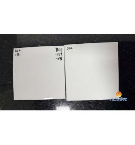 What should be done if black spots appear on enamelware made with white enamel frit?